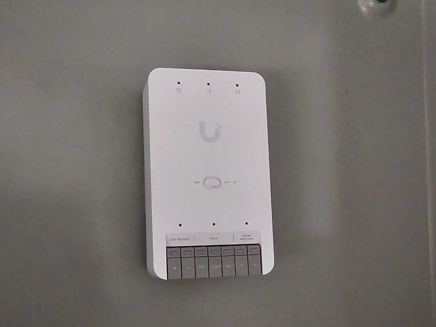 A Ubiquiti door hub installed by KeenAI inside a metal enclosure with terminated exit request, lock and door position wiring
